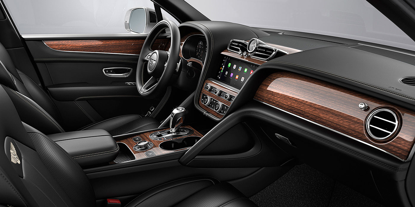Bentley Chengdu - Jinniu Bentley Bentayga interior with a Crown Cut Walnut veneer, view from the passenger seat over looking the driver's seat.
