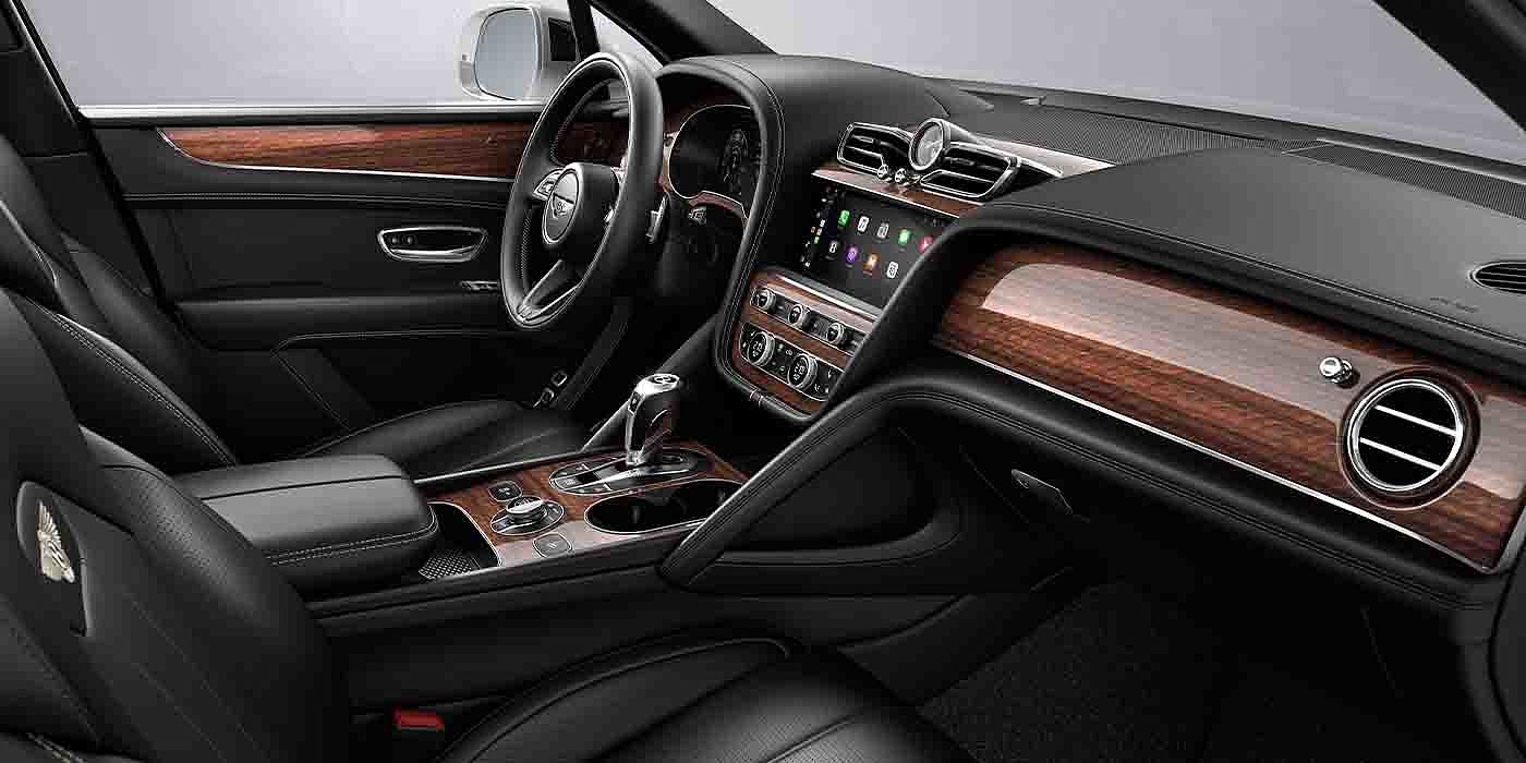 Bentley Chengdu - Jinniu Bentley Bentayga EWB interior with a Crown Cut Walnut veneer, view from the passenger seat over looking the driver's seat.